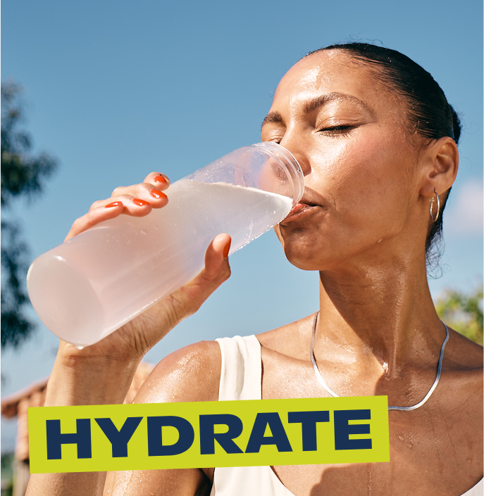 women is drinking liquid iv electrolyte powder and getting hydrated